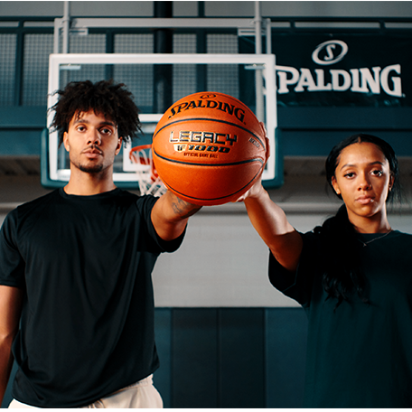 Male and female model hold Legacy TF-1000 basketball.